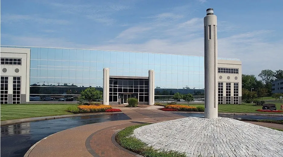 A large building with a tall tower in the middle of it.