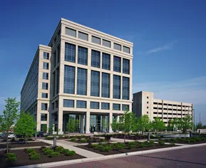 A large building with many windows and trees